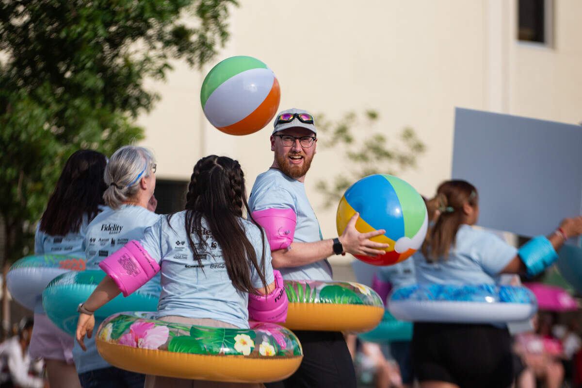 Fidelity Bank River Run participants walk down Main at the beginning of the Star Lumber Sundown Parade on May 31. The parade was one of the events to kick off the first day of Riverfest.