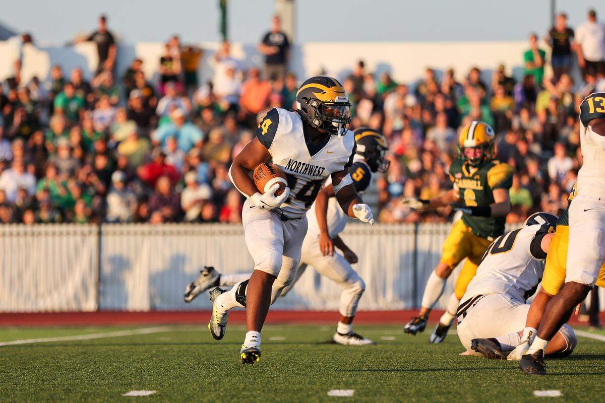 Wichita Northwest running back L.J. Phillips looks for a hole against the Bishop Carroll defense in Friday’s game.