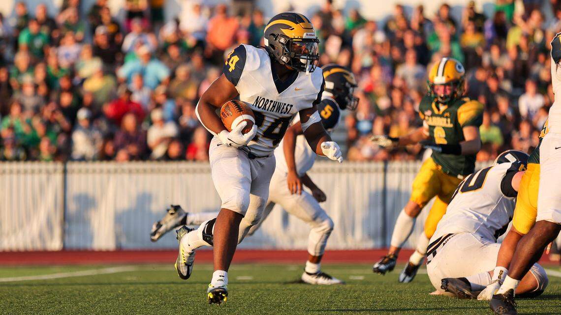 Wichita Northwest running back L.J. Phillips looks for a hole against the Bishop Carroll defense in Friday’s game.