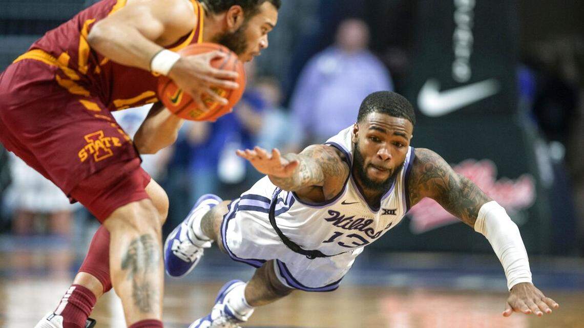 Kansas State’s Desi Sills lunges for the ball against Iowa State’s Jaren Holmes during the second half of an NCAA college basketball game on Saturday, Feb. 18, 2023 in Manhattan, Kan. (AP Photo/Travis Heying)