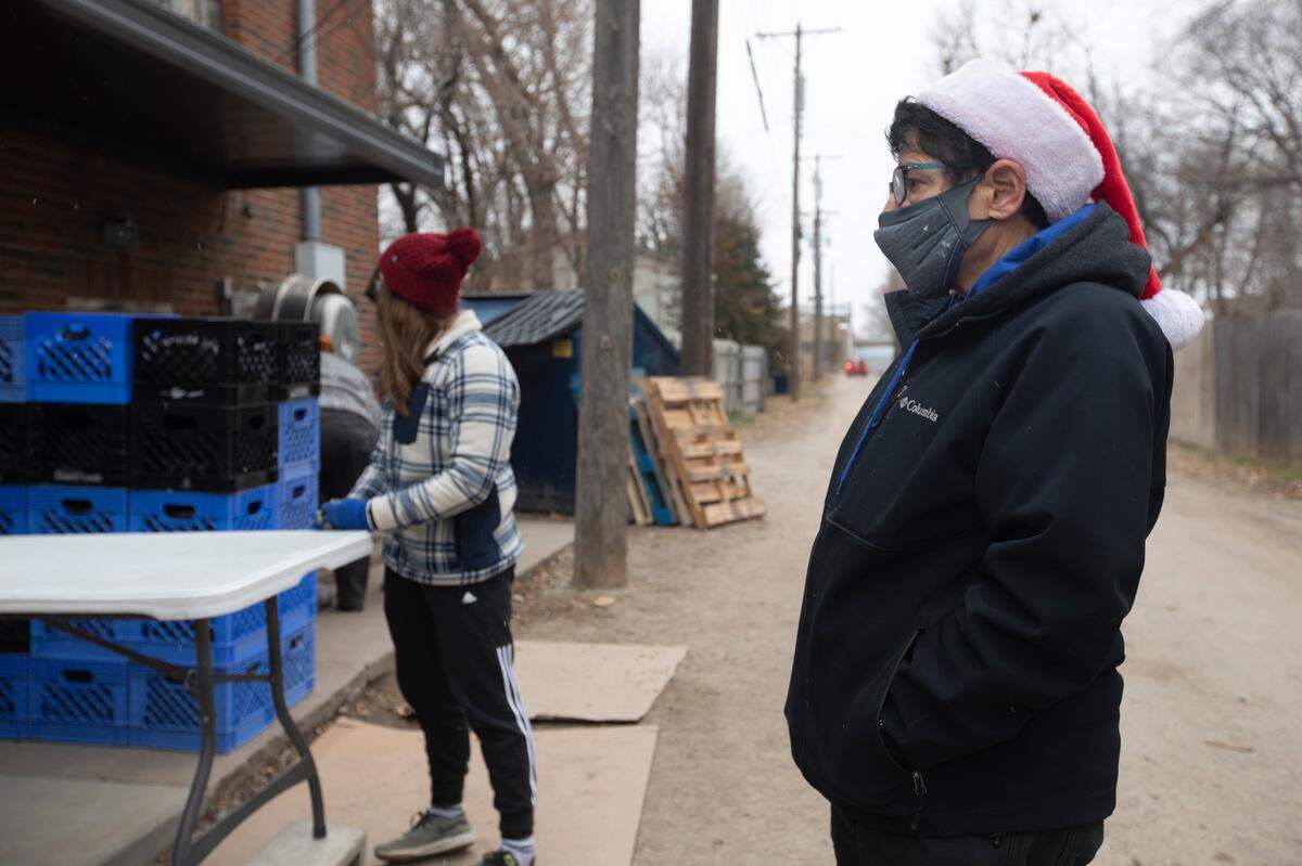 Rev. Jackie Carter waits to greet people at the First Metropolitan Community Church Table of Hope’s weekly food giveaway. The group serves food to 1,500-1,700 families per week. (December 15, 2020)