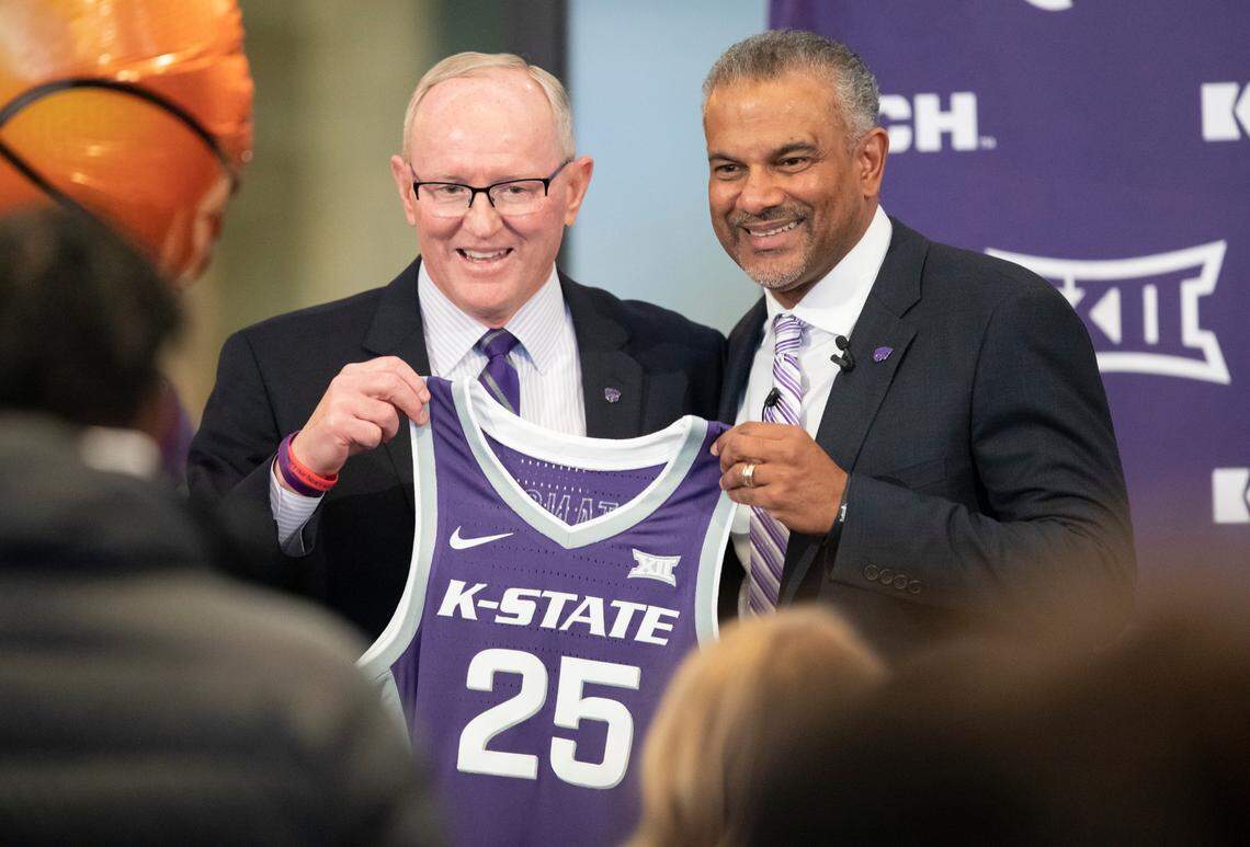 New Kansas State men’s basketball coach Jerome Tang holds up a jersey with athletic director Gene Taylor during Tang’s introductory news conference at Bramlage Coliseum in Manhattan on Thursday. Tang, a long time assistant at Baylor, replaces Bruce Weber, who resigned recently following a string of disappointing seasons.