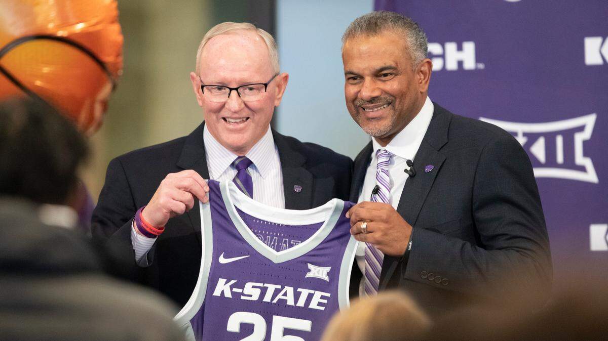 New Kansas State men’s basketball coach Jerome Tang holds up a jersey with athletic director Gene Taylor during Tang’s introductory news conference at Bramlage Coliseum in Manhattan on Thursday. Tang, a long time assistant at Baylor, replaces Bruce Weber, who resigned recently following a string of disappointing seasons.