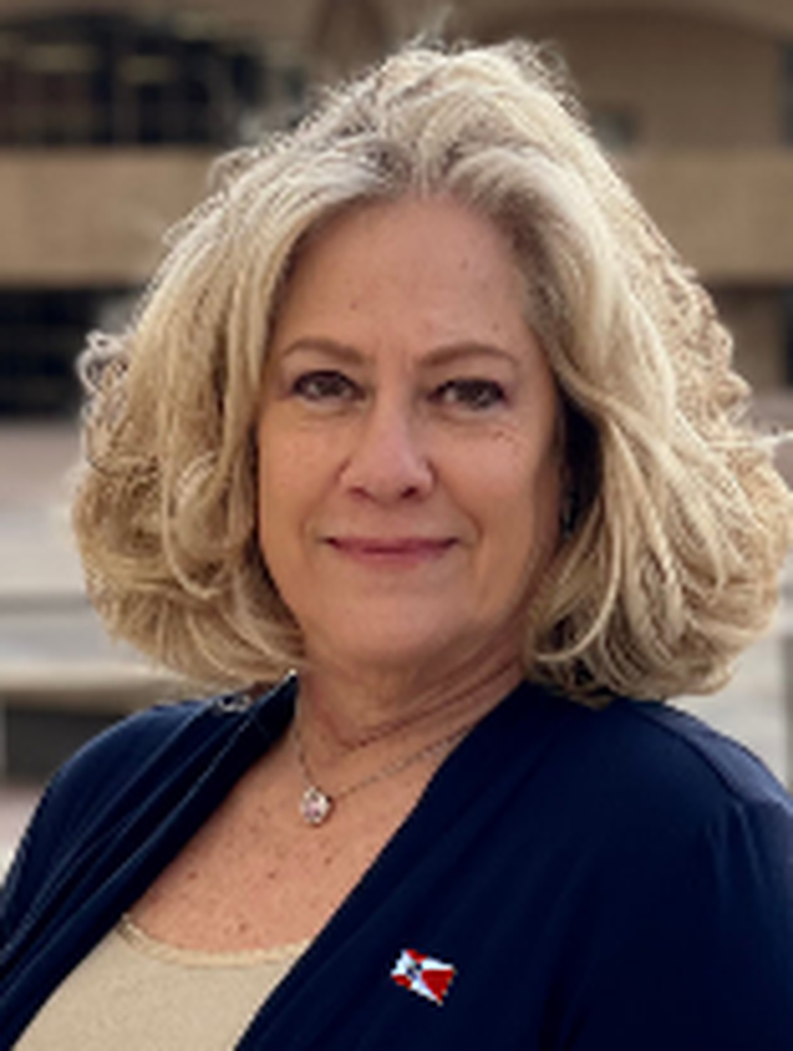Celeste Racette, a candidate for Wichita mayor in 2023, poses in front of Century II, which she successfully registered on Kansas Historic Registry.