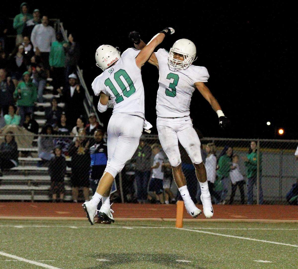Derby senior defensive backs Migc Aiyanyor (3) and Dax Benway (10) celebrate after a stop in the Panthers’ 24-6 win at Bishop Carroll on Friday. (Sept. 21, 2018)