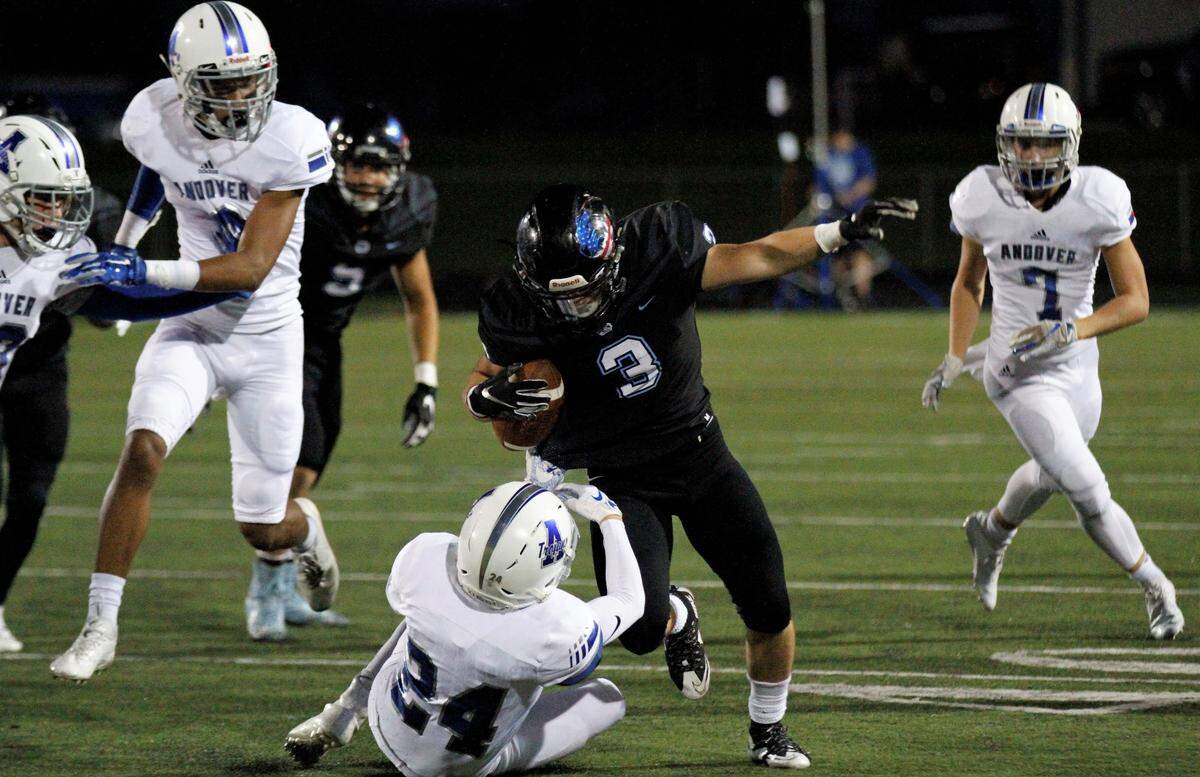 Goddard Eisenhower junior running back Colton Mackinnon runs over a defender in the Tigers’ 30-22 loss to Andover on Thursday night. (Sept. 13, 2018)