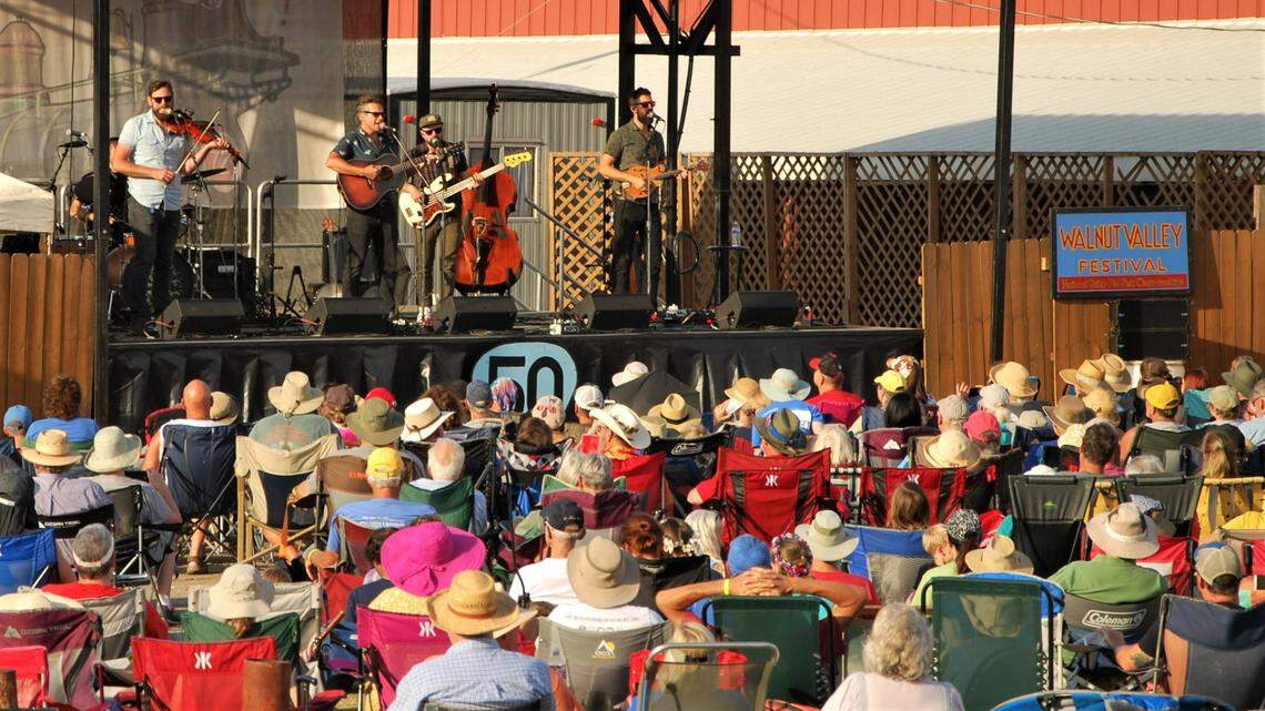 Music fans listen to the band The Steel Wheels at the 2022 Walnut Valley Festival.