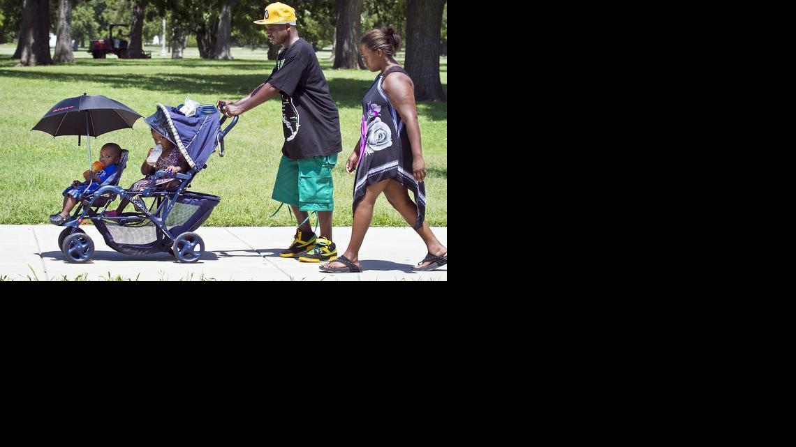 Tony and Jaleesa Roberts take a stroll in Central Riverside Park on Friday with their kids Junior, 1, and Honesty, 3. (July 11, 2014) 

