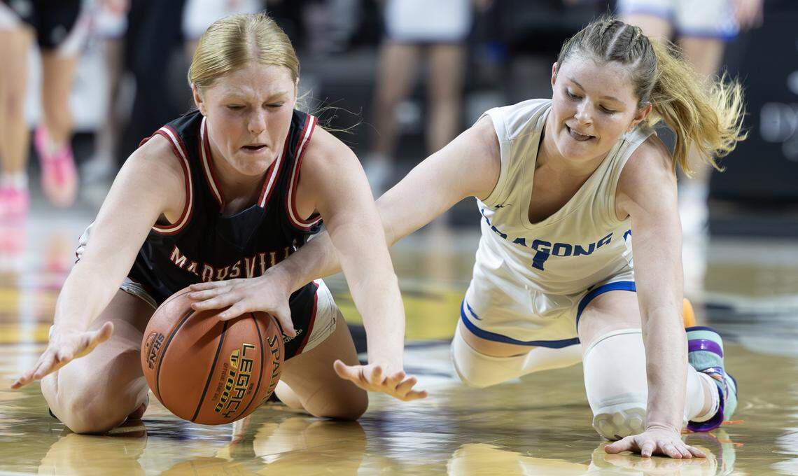 Halstead’s Addison Wills, right, dives for a loose ball against Maryville’s Aubrey Dressman during the second quarter of their class 3A quarter final game at Koch Arena on Wednesday.