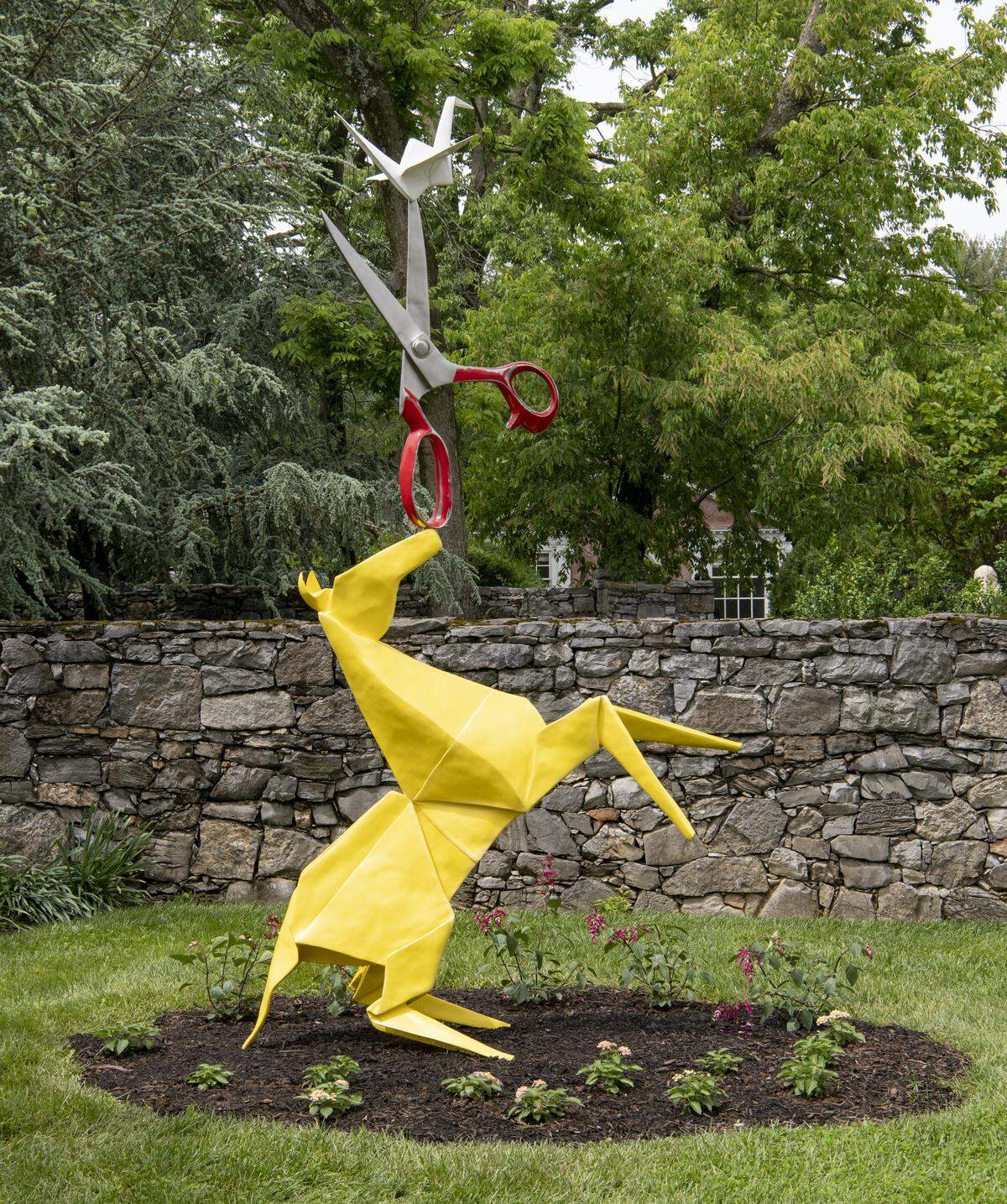 This sculpture is called Balancing Act, and it features sculptures based off both a kirigami and an origami creation. The yellow horse is based off of the kirigami piece, while the crane on top of the scissors is based on a traditional origami creation.