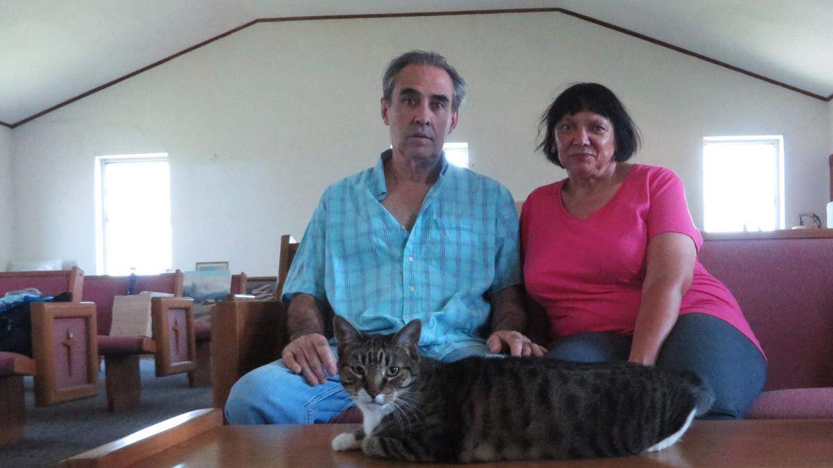 Mike Rosseau and wife Dorothy Tobe, with cat Daisy, inside the church they bought to renovate into a home in St. John