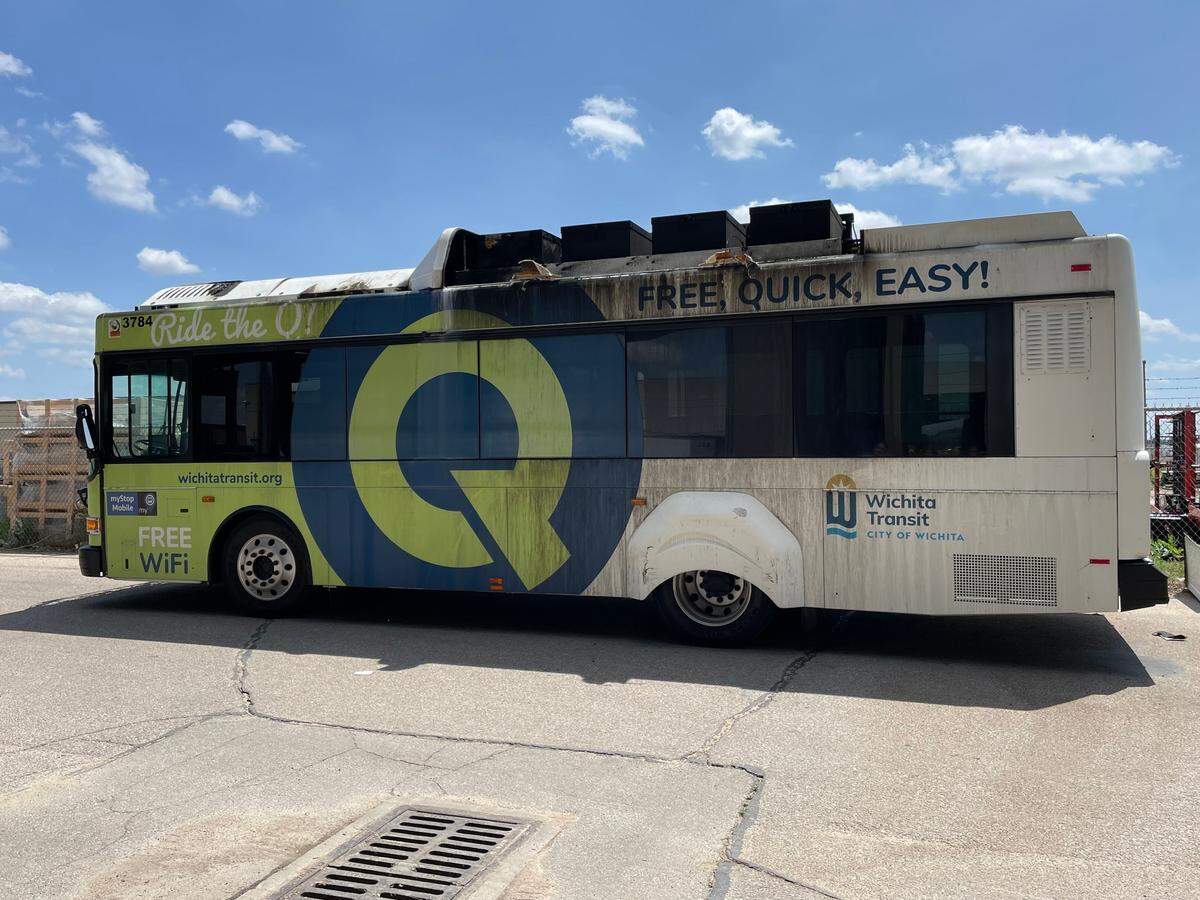 A city transit electric bus that caught fire early Wednesday sits in the lot of the Wichita transit building near Downtown Wichita. City officials say it will inspected and hauled off for good.