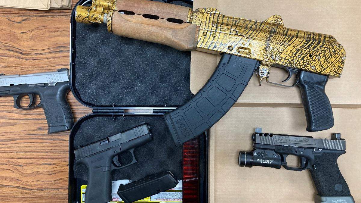 Four guns, including a customized AK-47 pistol, were seized when police searched a home in Wichita. A teen was arrested.
