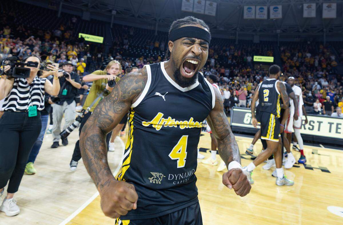 Marcus Keene celebrates after his three pointer gave the Aftershocks the 66-63 win over Forever Coogs in the quarterfinal of the TBT Tournament at Koch Arena on Tuesday night.