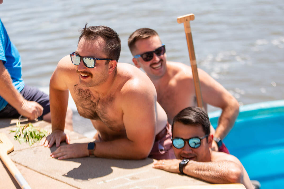 Participants in the cowboy bathtub races climb out of their stock tanks after racing across the width of the Arkansas River near Delano on Saturday.