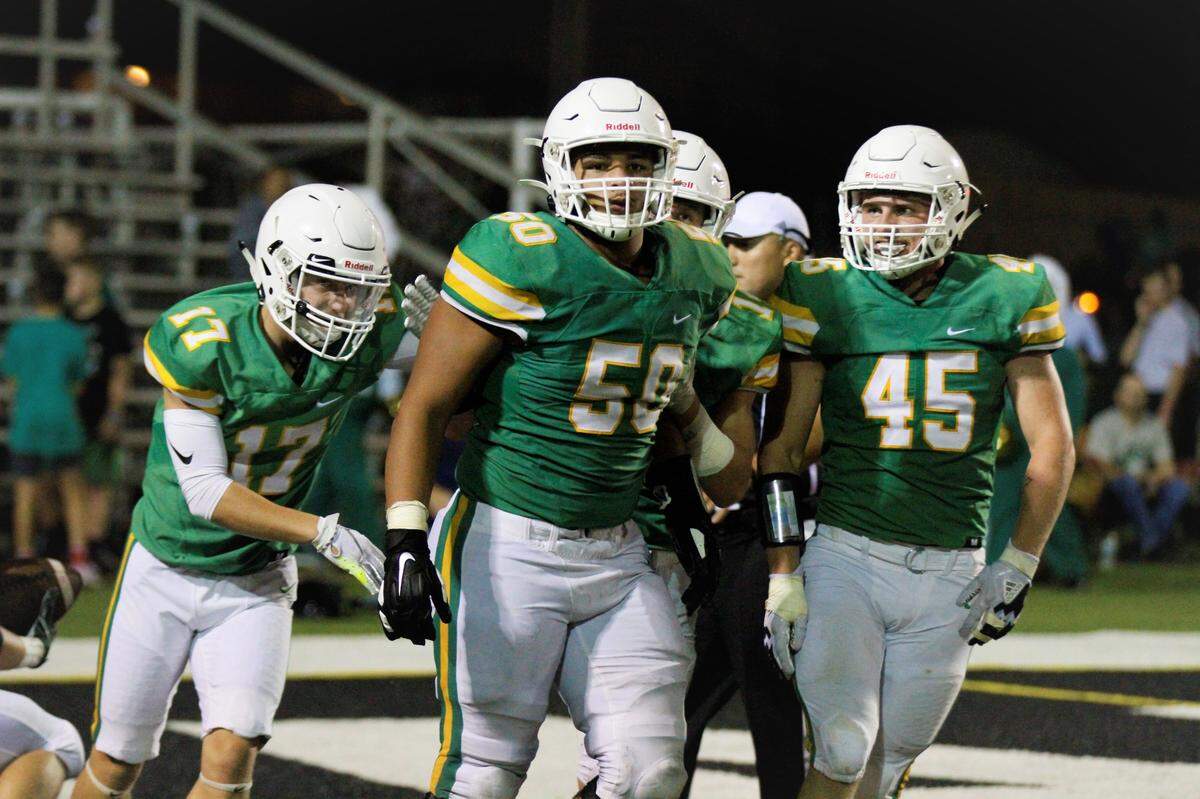 Derby’s Brecken Kooser (left), Tyler Dorsey (center) and Seth Smith (right) celebrate a key moment during Friday’s game against Carroll.
