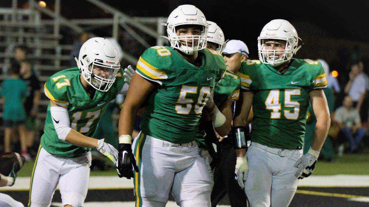 Derby’s Brecken Kooser (left), Tyler Dorsey (center) and Seth Smith (right) celebrate a key moment during Friday’s game against Carroll.