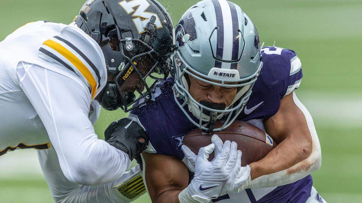 Kansas State’s Deuce Vaughn takes a hard hit from Missouri defender Jaylon Carlies during the third quarter of their game on Saturday, Sept. 10, 2022, in Manhattan.