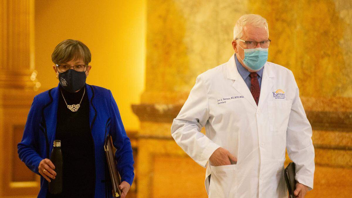 Kansas Gov. Laura Kelly, and Lee Norman, Kansas secretary of health and environment, walk to a news conference where Kelly announced a three-stage approach to COVID-19 vaccine distribution for the state on Wednesday, Dec. 2, 2020.