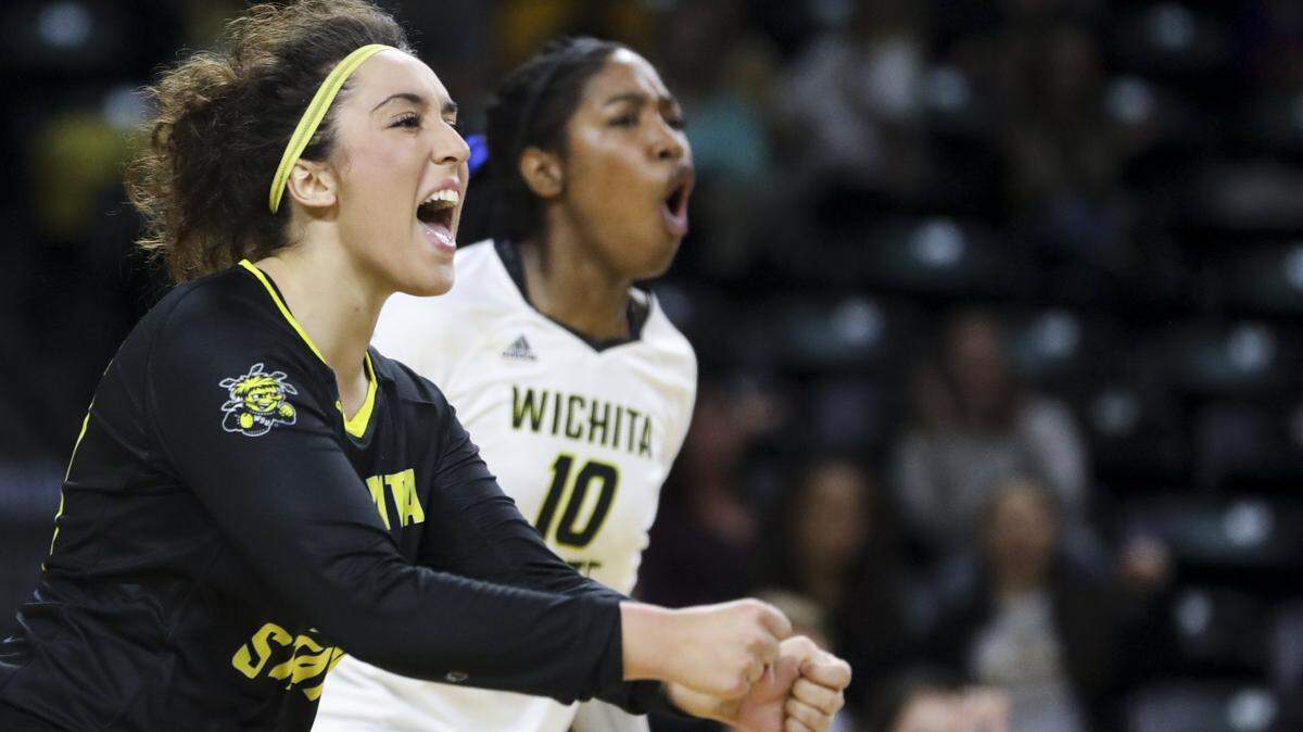 Wichita State libero Giorgia Civita and outside hitter Tabitha Brown celebrate a point against the Tulane Green Wave during the home-opener in Koch Arena. (Sept. 21, 2018)