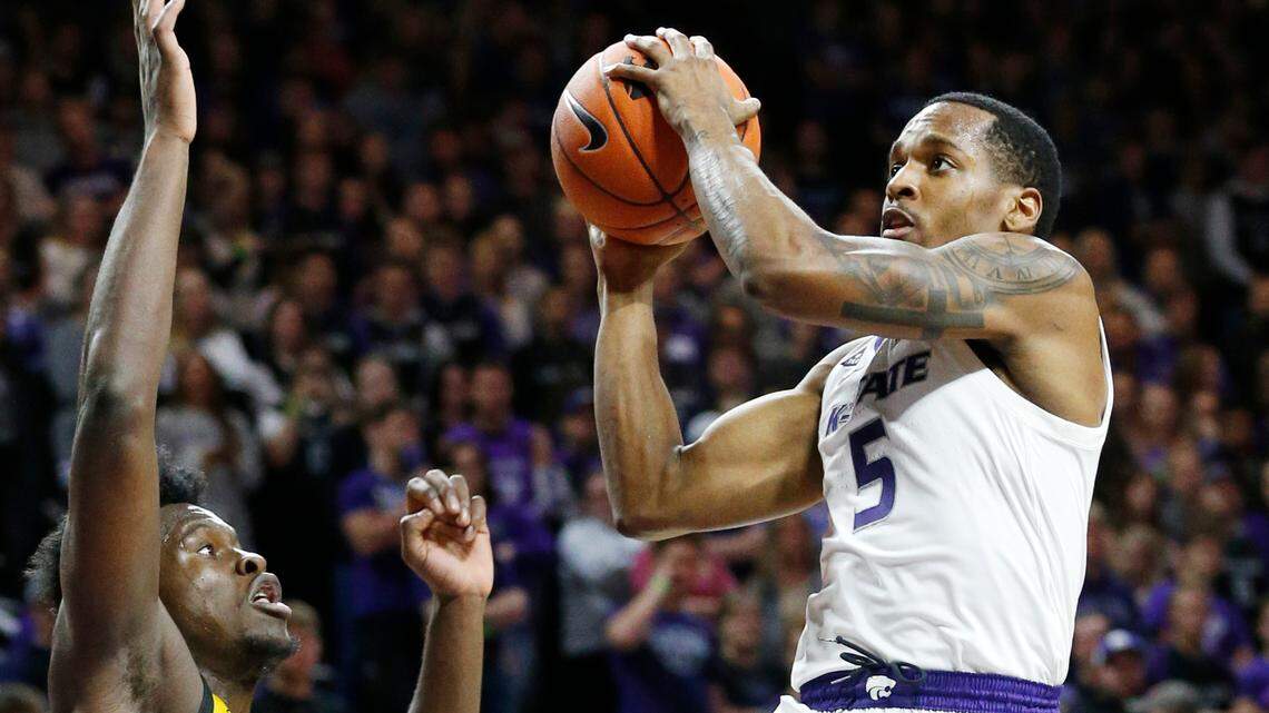 K-State guard Barry Brown Jr. (5) drives for the net Friday night against Kennesaw forward Isaac Mbuyamba (5) during K-State’s home opener. (November 9, 2018)