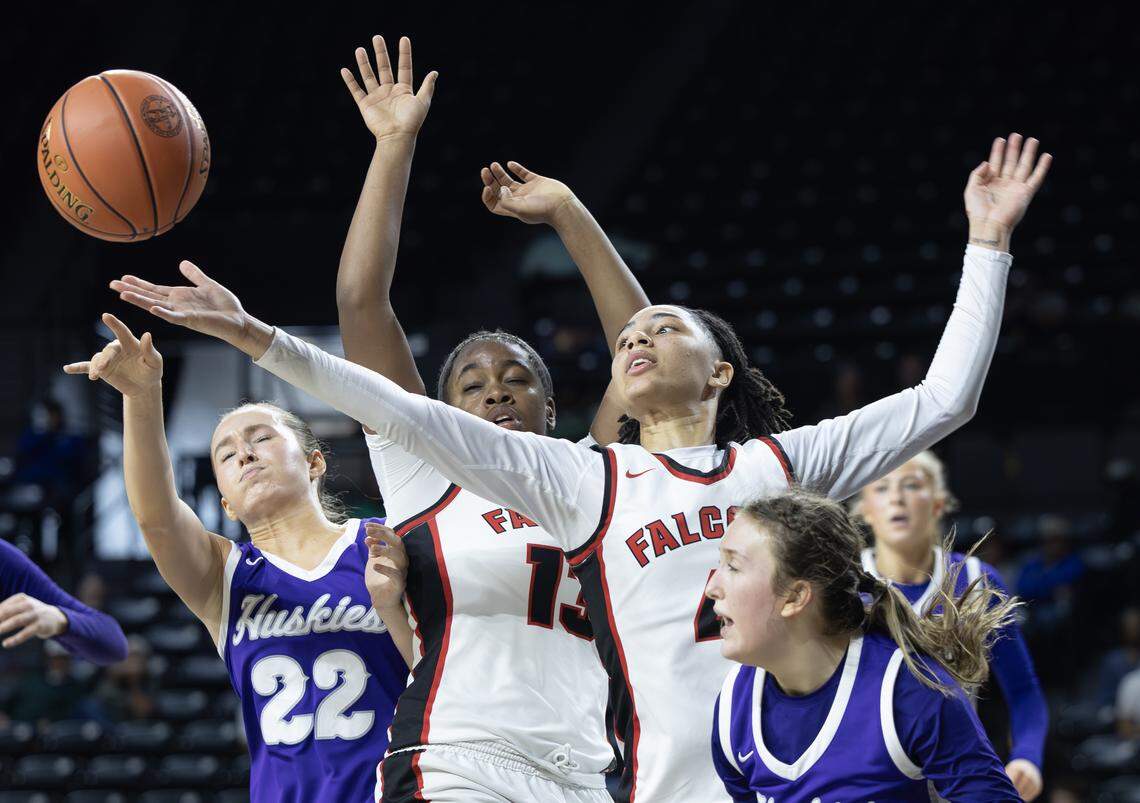 Wichita Heights’ player Aniyah Harris (4) and Ashlynn Reed (13) fight for a rebound against Blue Valley Northwest’s Milena Domazet, left, and Molly Numrich, right on Tuesday at the quarterfinals of the 6A basketball tournament at Koch Arena. Blue Valley Northwest upset the top-ranked Falcons.