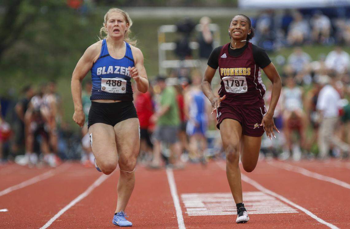 Gardner-Edgerton’s Kendra Wait, left, and Wichita West’s Lajada Owens battle it out in the 6A 100 meter dash at the Track and Field State Championships at Cessna Stadium Saturday. Wait edged out Owens to win the race with a time of 12.04. (May 25, 2019)