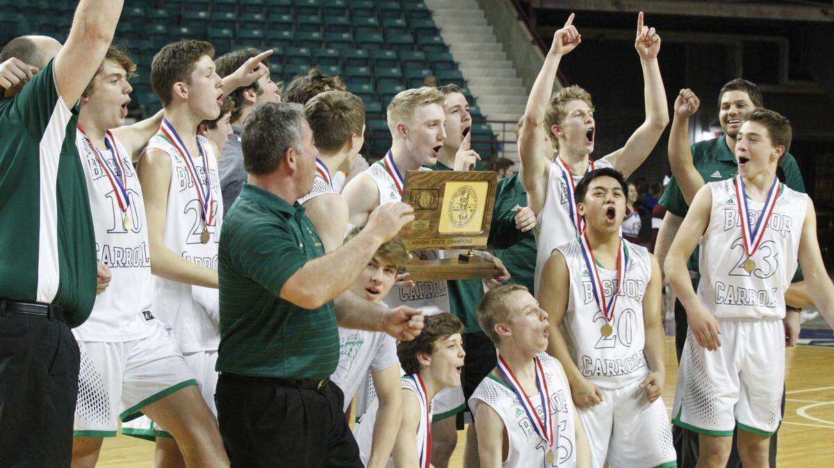 The Bishop Carroll boys basketball team celebrates its first state championship in school history. The Golden Eagles beat Salina Central 43-41 in overtime in the Class 5A final Saturday, March 10, 2018, at the Kansas Expocentre in Topeka.