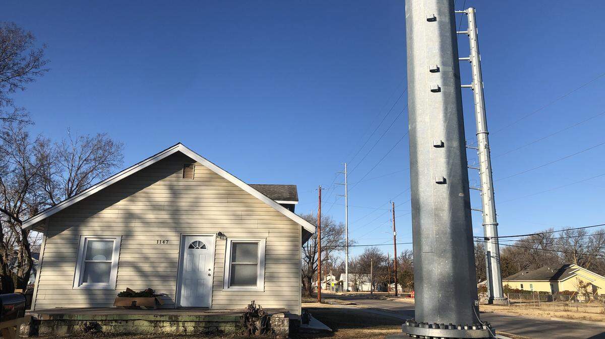 New power poles tower over homes at 11th St. North and Green in Wichita.