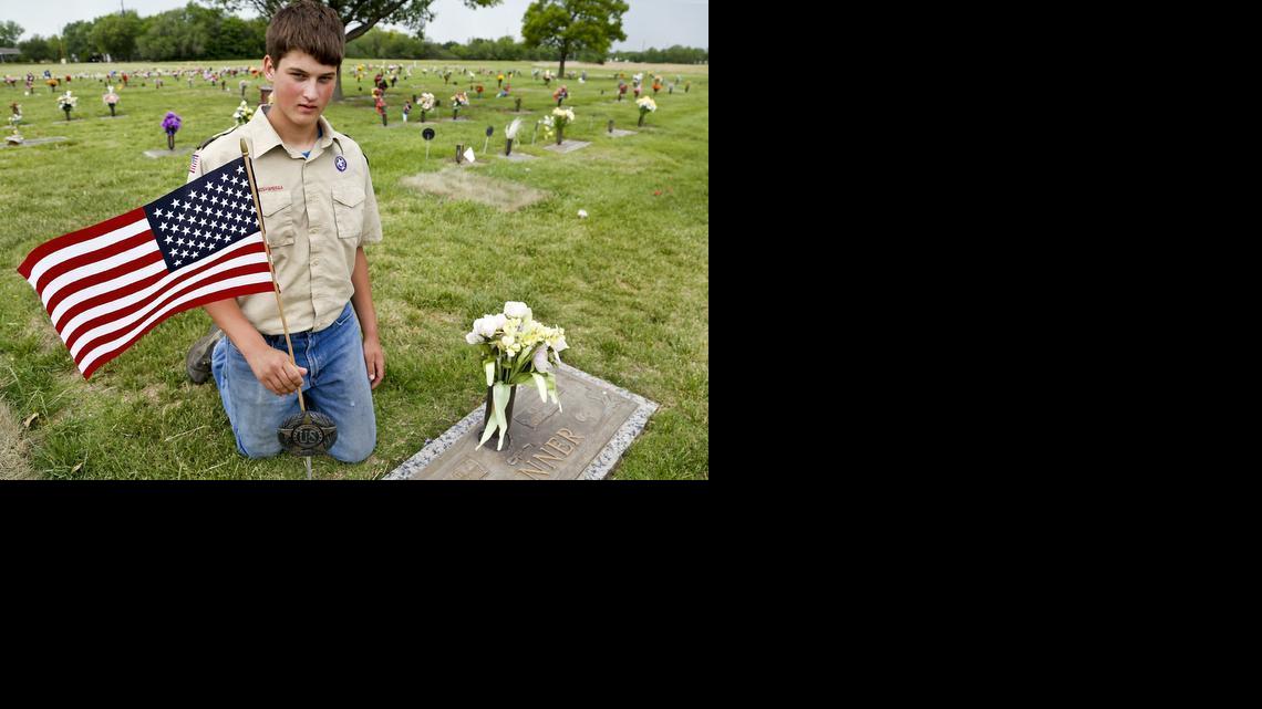 Boy Scout Jared Jacobs, 16, who is working on his Eagle Scout award, is among 20 to 25 Scouts who mark veterans’ graves with flags at Resthaven Mortuary. (May 22, 2014) 

