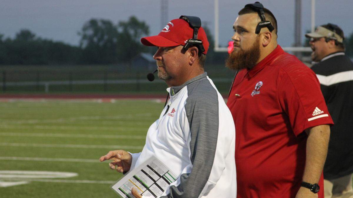 Former Coffeyville head football coach Aaron Flores (left) died from complications of COVID-19 last Friday at age 50. Coaches and athletes remember Flores as an inspirational figure after receiving a double lung transplant and still coaching.