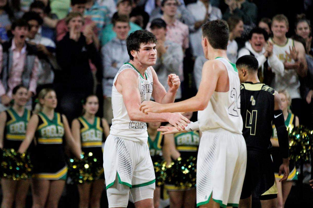 Bishop Carroll senior Tanner Mans (left) and junior Alex Littlejohn (right) celebrate a bucket against Andover Central in the 2019 AVCTL/GWAL Challenge.