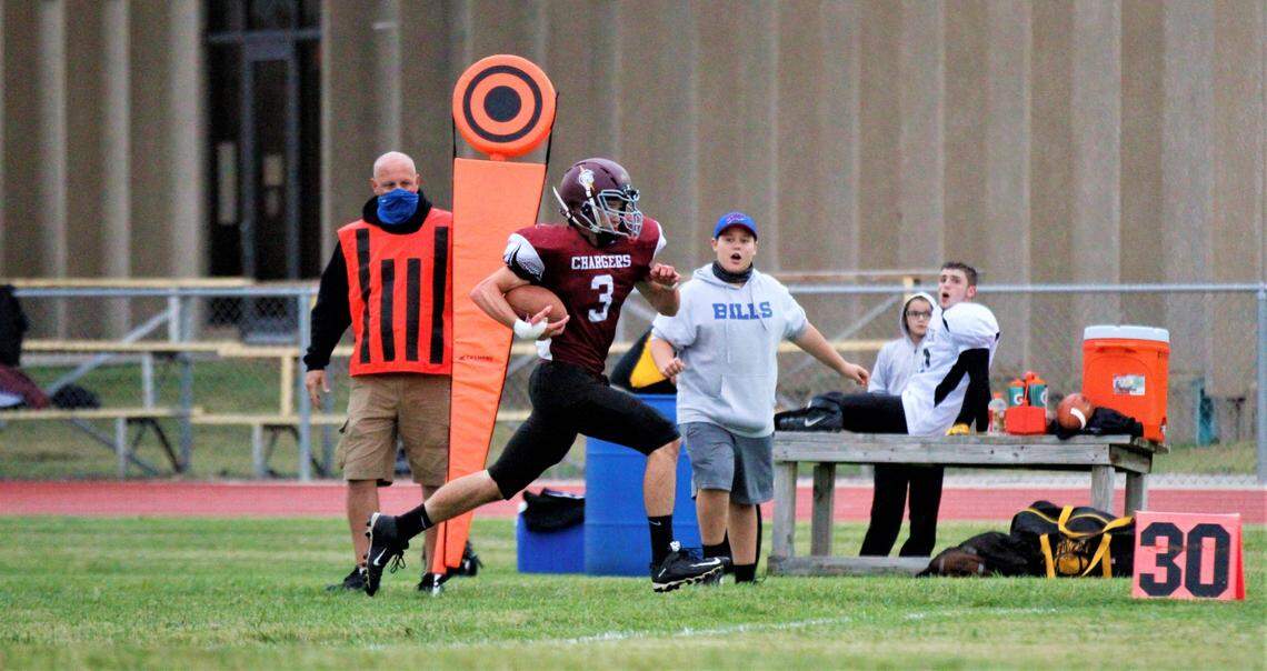 Burrton junior running back Gabe Perkins sprints down the Fowler sideline on his way for a touchdown in the Chargers’ 71-34 home win Friday.