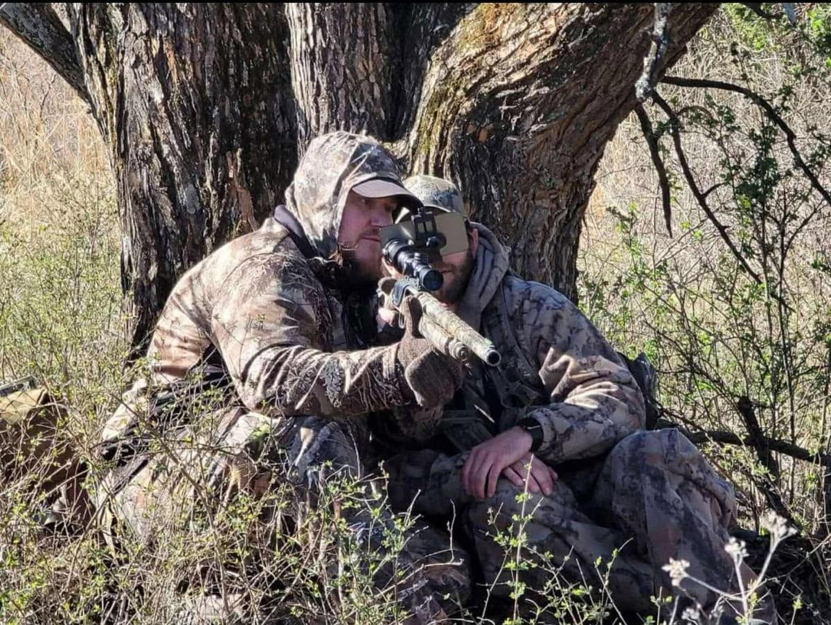 William Murphy’s guide, David Williams, helps the legally blind, Kansas veteran hunt while looking onto a phone screen instead of through the scope.