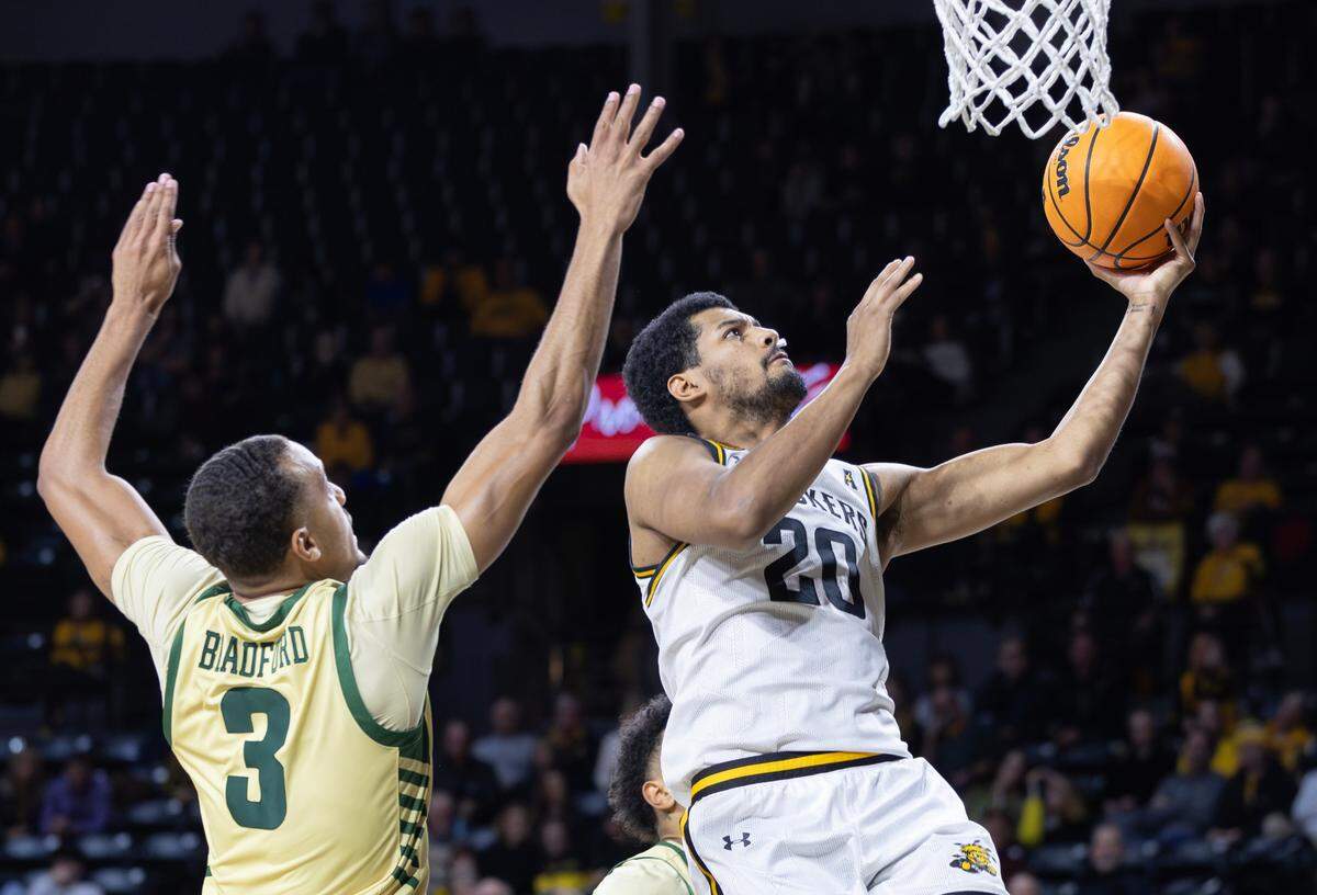 Wichita State’s Harlond Beverly makes a layup against Charlotte’s Ben Bradford during the second half of their game on Tuesday night at Koch Arena.