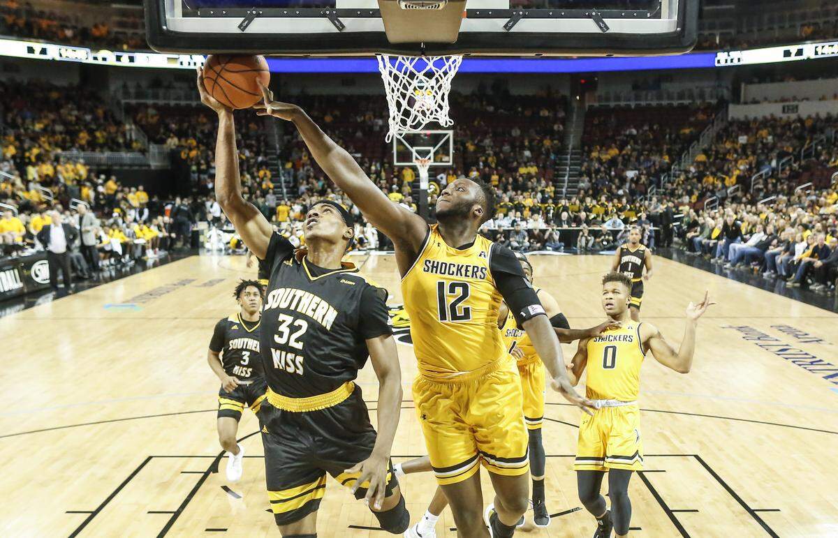 Wichita State forward Morris Udeze blocks the shot of Southern Miss forward Leonard Harper-Baker during the first half of their game at Intrust Bank Arena on Saturday.