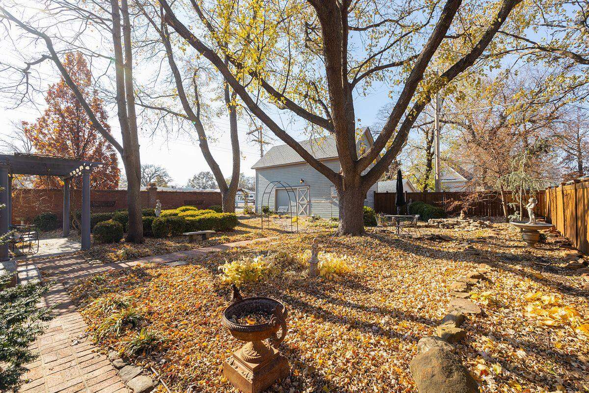The backyard of the historical Martha A. Kiefer House includes a waterfall and a koi pond.