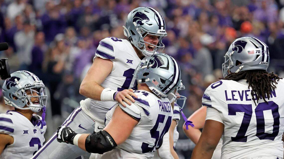 Kansas State Wildcats quarterback Will Howard (18) celebrates with teammates after scoring a touchdown during the first half against the TCU Horned Frogs at AT&T Stadium on Dec. 3, 2022.