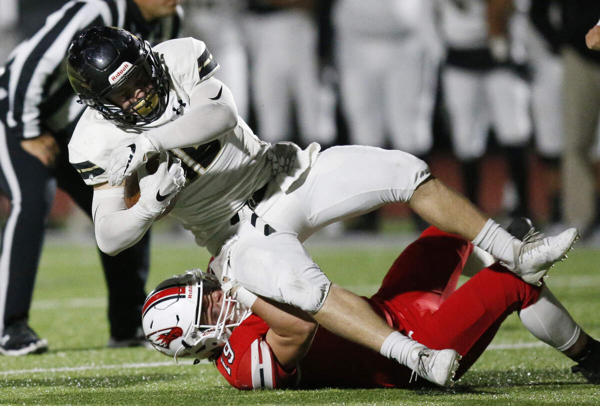 Maize South running back #18 Mason Edwards is pulled down by Maize defender #19 Carson Wheeler. (November 2, 2018)