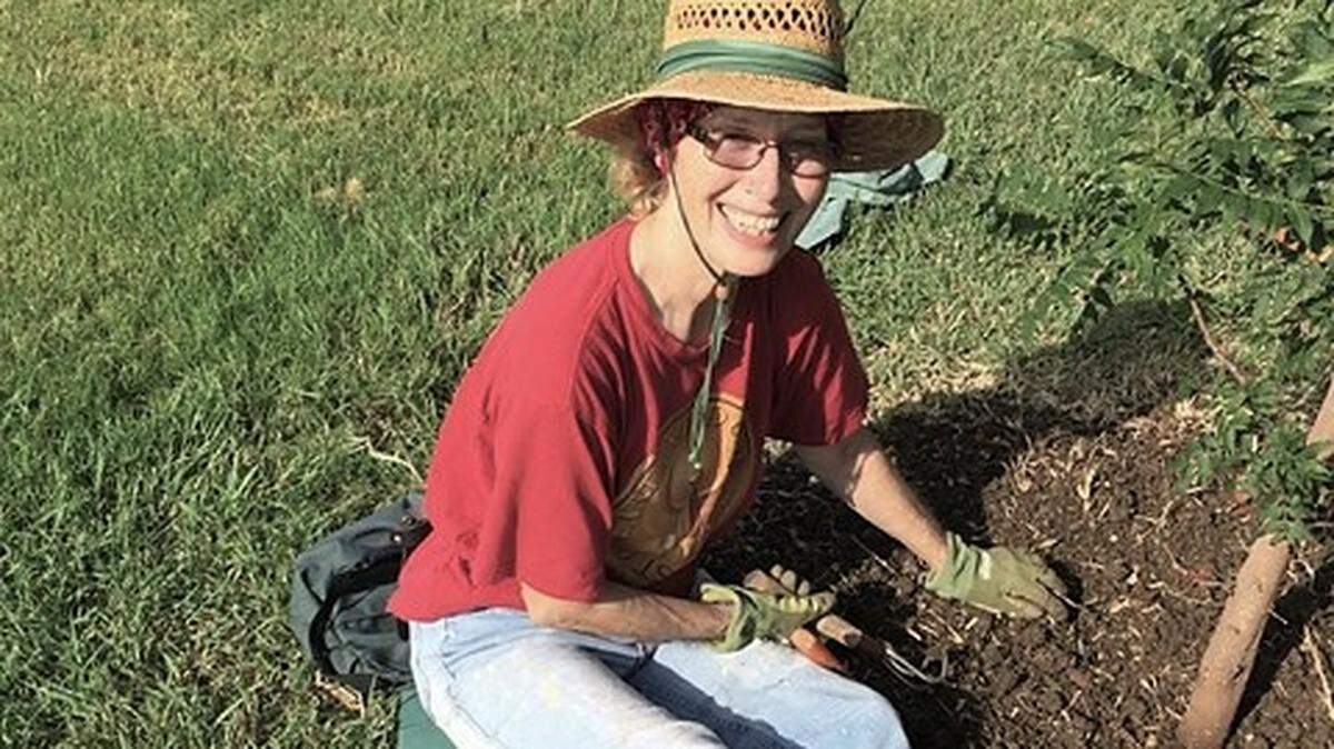Former state Rep. and tree master gardener Elizabeth Bishop plants a tree.