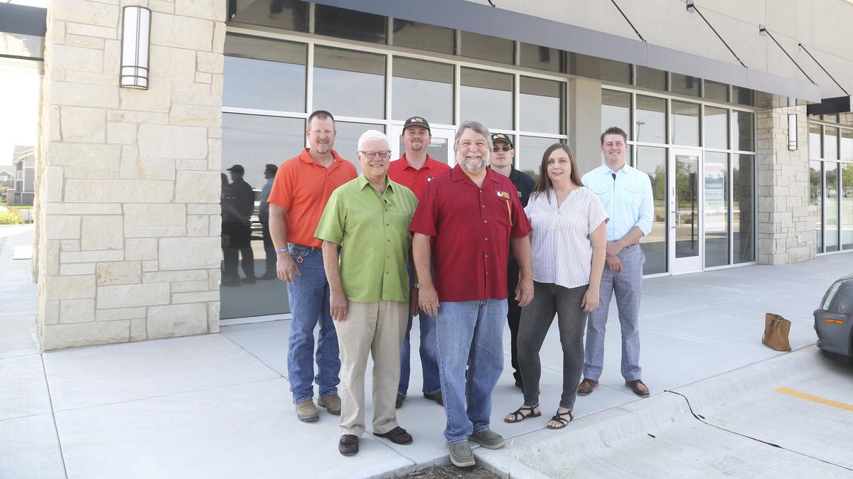 Chick N Max founder Max Sheets (center) surrounded by his team outside a planned Chick N Max on North Maize Road. From left: Doug Bird and Tony Caputo of Accel Construction; Kodi Koerner, Jesse Vanderpool and Sarah Selmon of Chick N Max; and Dylan Schellenberg of Re/Max and the Fox Ridge Plaza development.