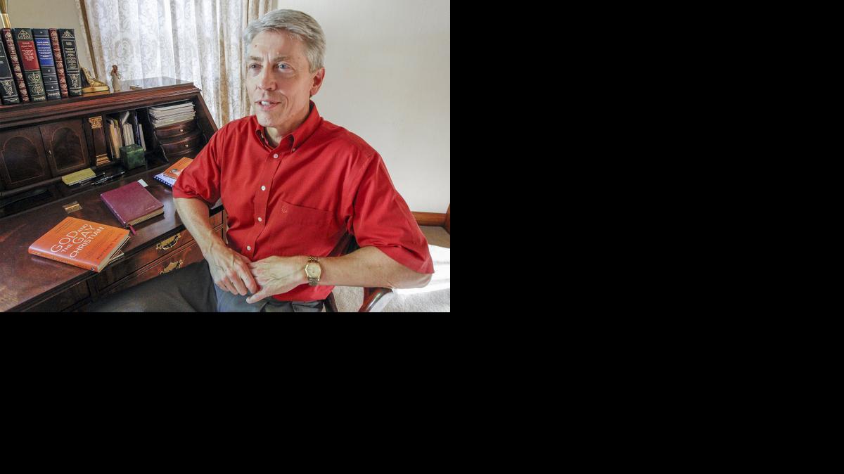 Monte Vines sits at his desk at his home with a copy of his son Matthew’s book, “God and the Gay Christian,” on Thursday. (June 5, 2014)

