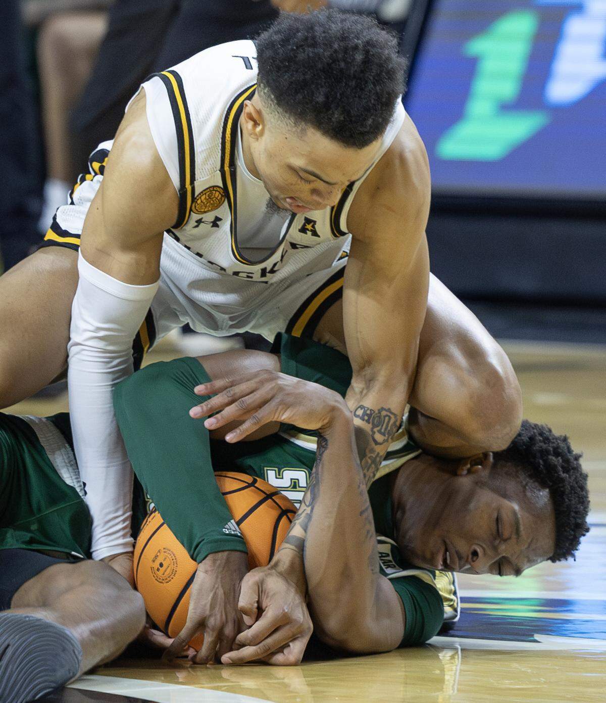 Wichita State’s Xavier Bell gets tied up with South Florida’s CJ Brown during the second half of their game on Monday night at Koch Arena.