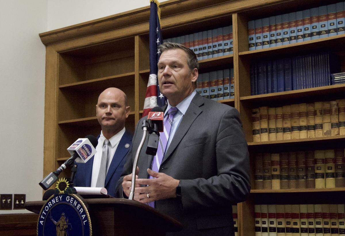 Kansas Attorney General Kris Kobach, at the podium, and Secretary of State Scott Schwab announced felony charges against Joe Ceballos, currently the Coldwater, Kansas, mayor. He is accused of voter fraud.