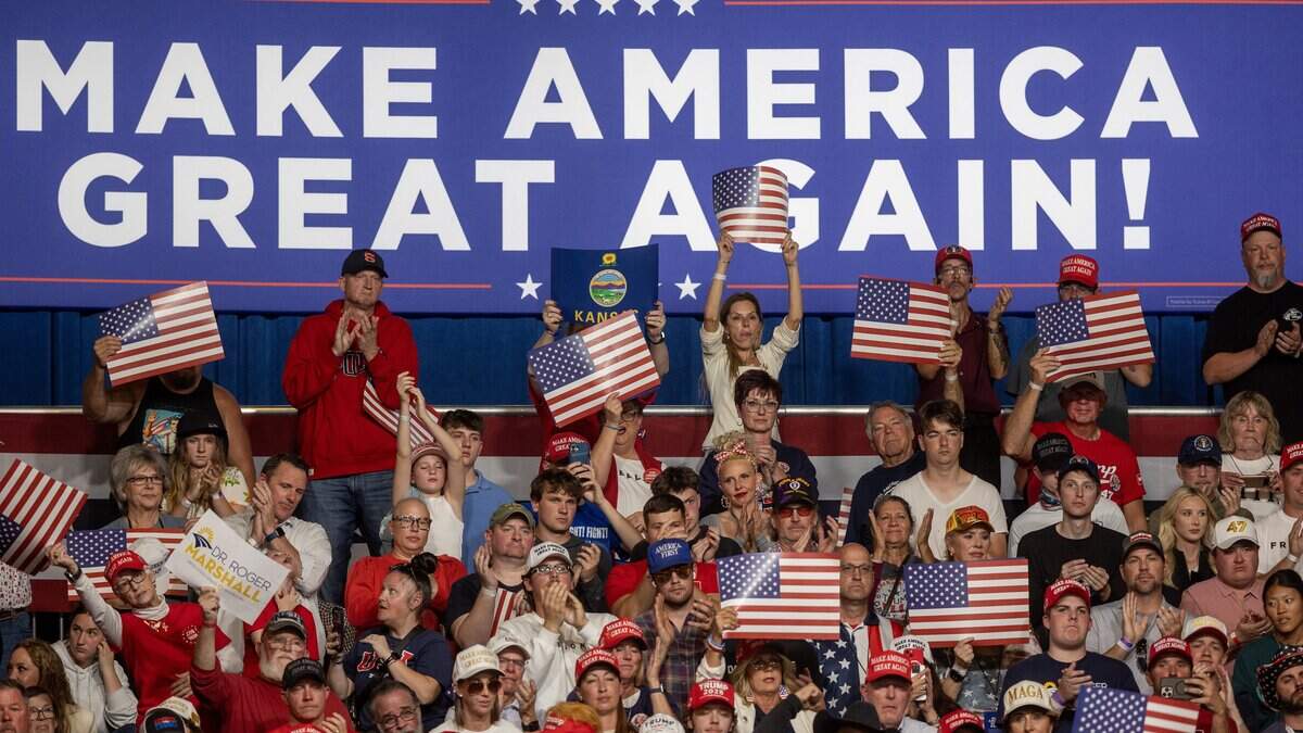 The crowd applauds President Trump during his rally at Heartland Credit Union Arena on Monday.