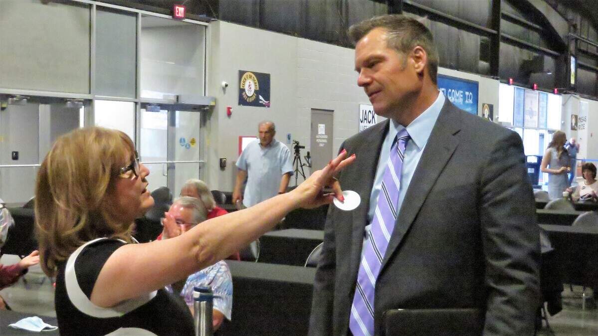 Senate candidate Kris Kobach (right) visits with Alta Segovia, president of Republican Women United, before his speech at the Hartman Arena Friday.