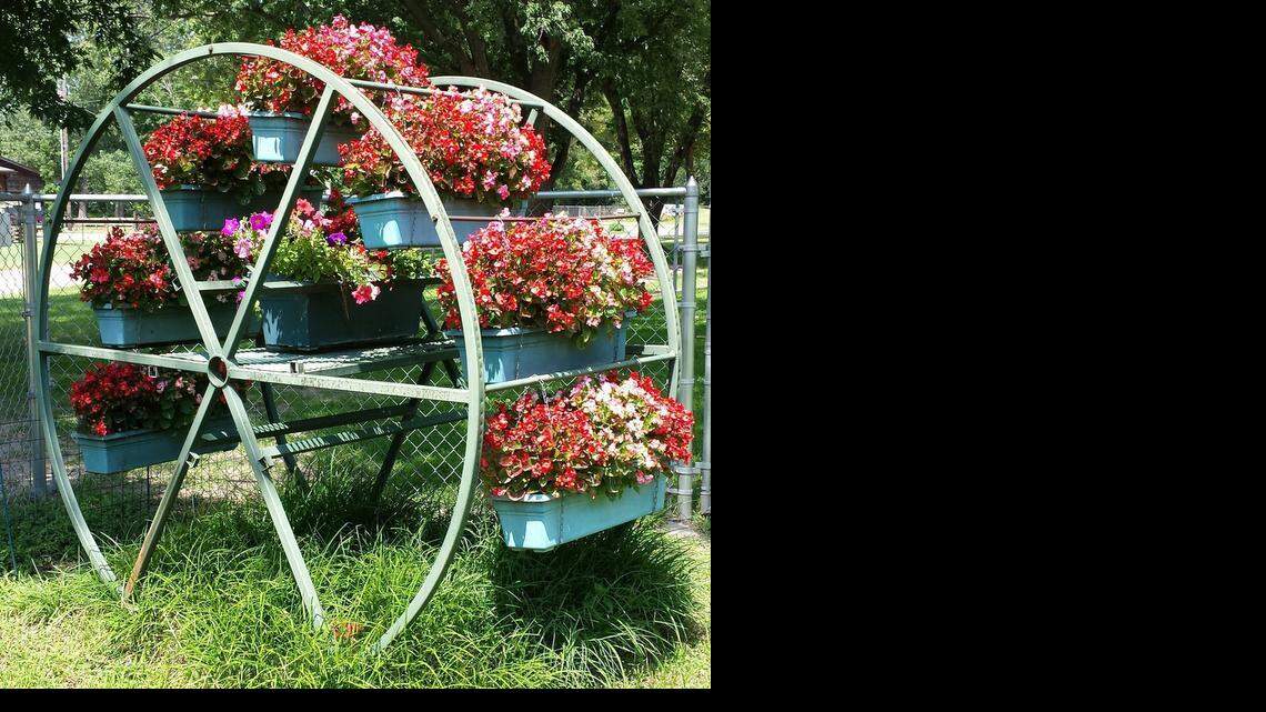 Stan Smith of Haysville added metal bars and a center shelf to a discarded cable spool, holding seven long containers of red and pink begonias, and petunias in the middle. “No muss, no fuss all summer!” Jen Smith reports. 

