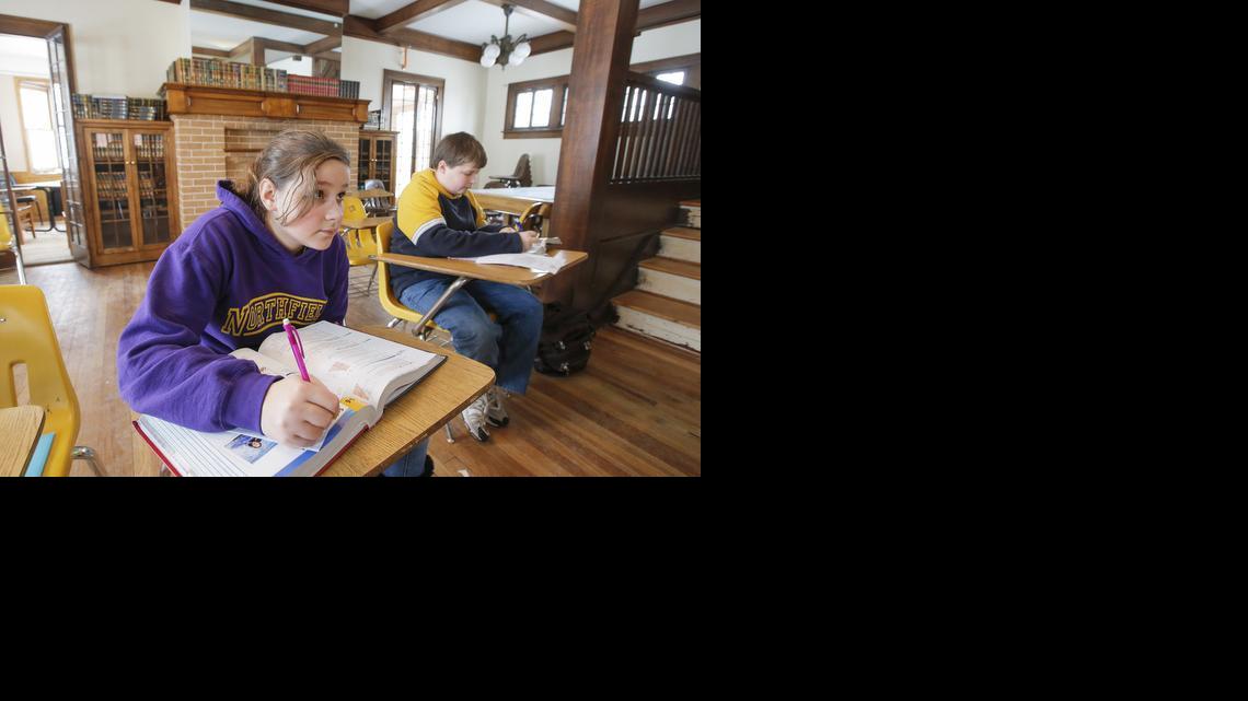 Josie Van Stipdonk, left, and Maverick Lewis study during an algebra class at the Northfield School on West University. The school is inside neighboring houses near Friends University. 

