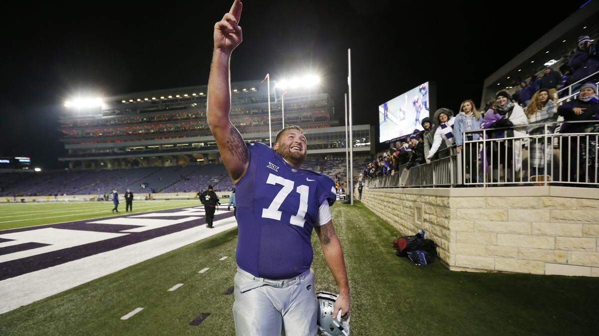 K-State offensive lineman Dalton Risner (71) salutes the K-State fans Saturday after his teammates circle Bill Snyder Family Stadium. (November 17, 2018)