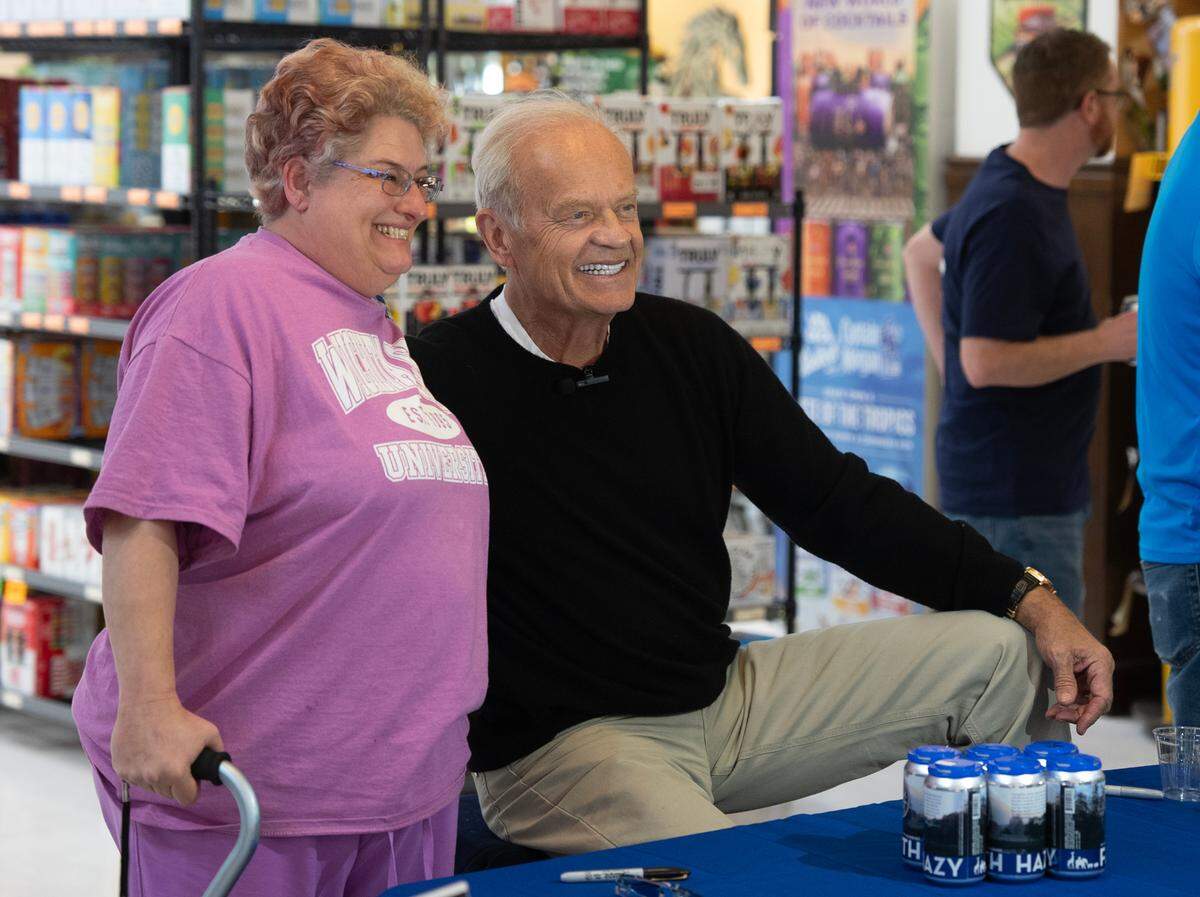Julia McKee poses for a photo with actor Kelsey Grammer on Wednesday at Jacob Liquor Exchange. It was Grammer’s first of 10 Wichita appearances that are planned around town though Saturday.